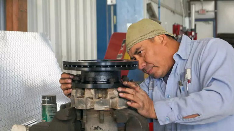 Trailer mechanic servicing a trailer axle and hub at Nationwide Trailers' service department