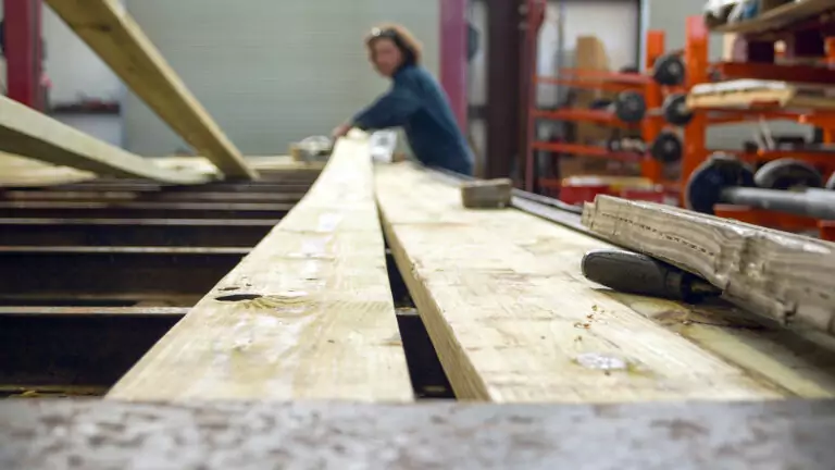 Trailer mechanic replacing decking on a flatbed trailer at Nationwide Trailer's service department